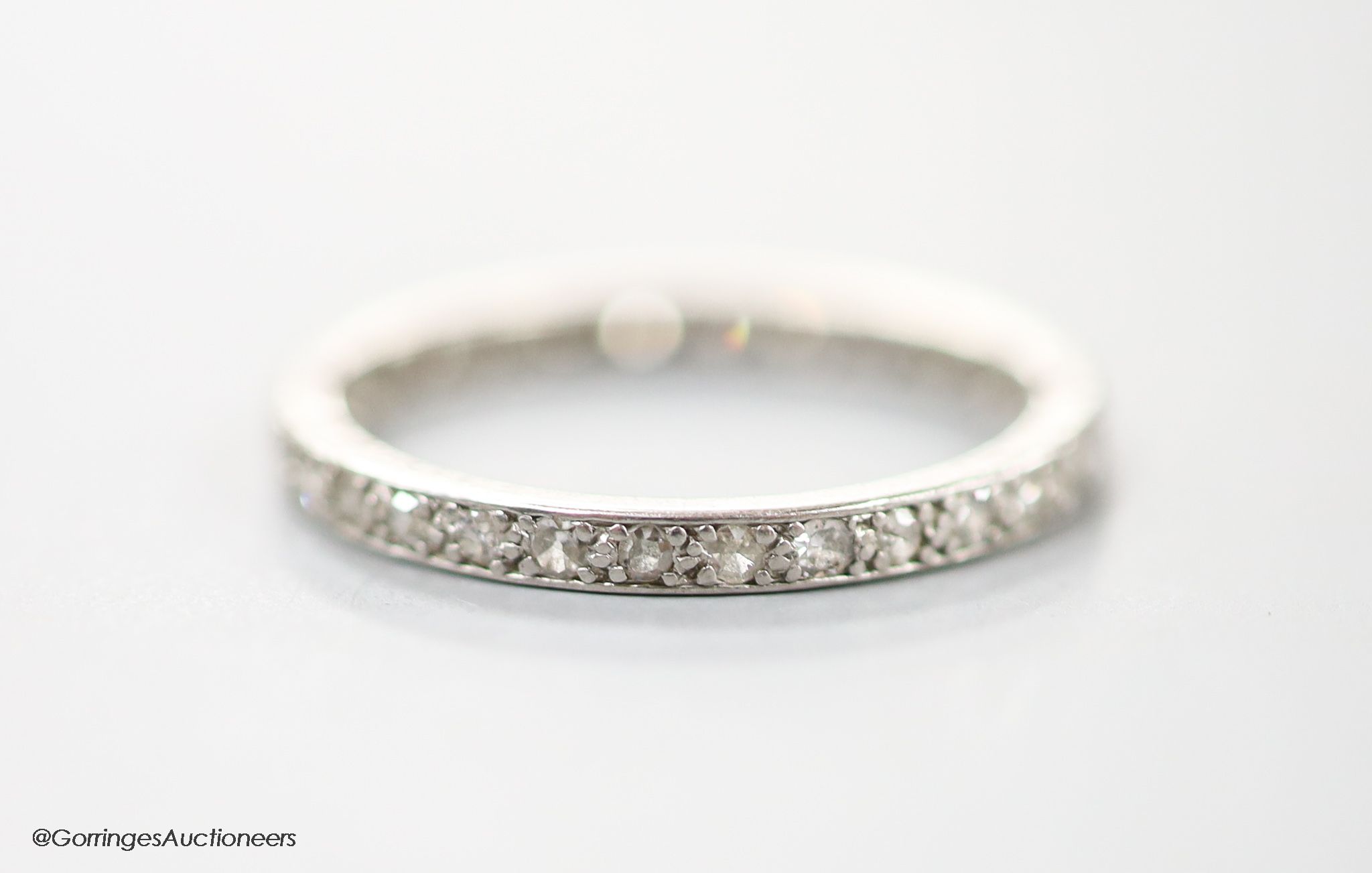 A white metal and diamond chip set full eternity ring, size L, gross 2.2 grams.